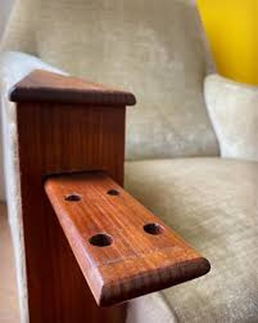 A sliding tray with holes on both sides of this sofa — what’s it for?