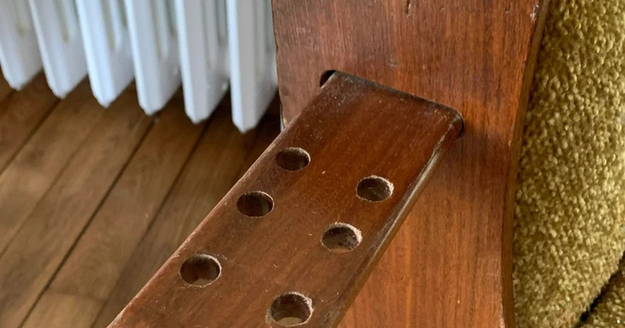 A sliding tray with holes on both sides of this sofa — what’s it for?